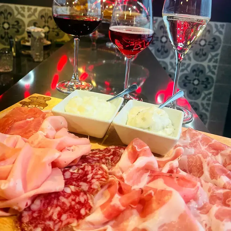 The board rich in cured meats, with the bowls of soft cheese, on my counter